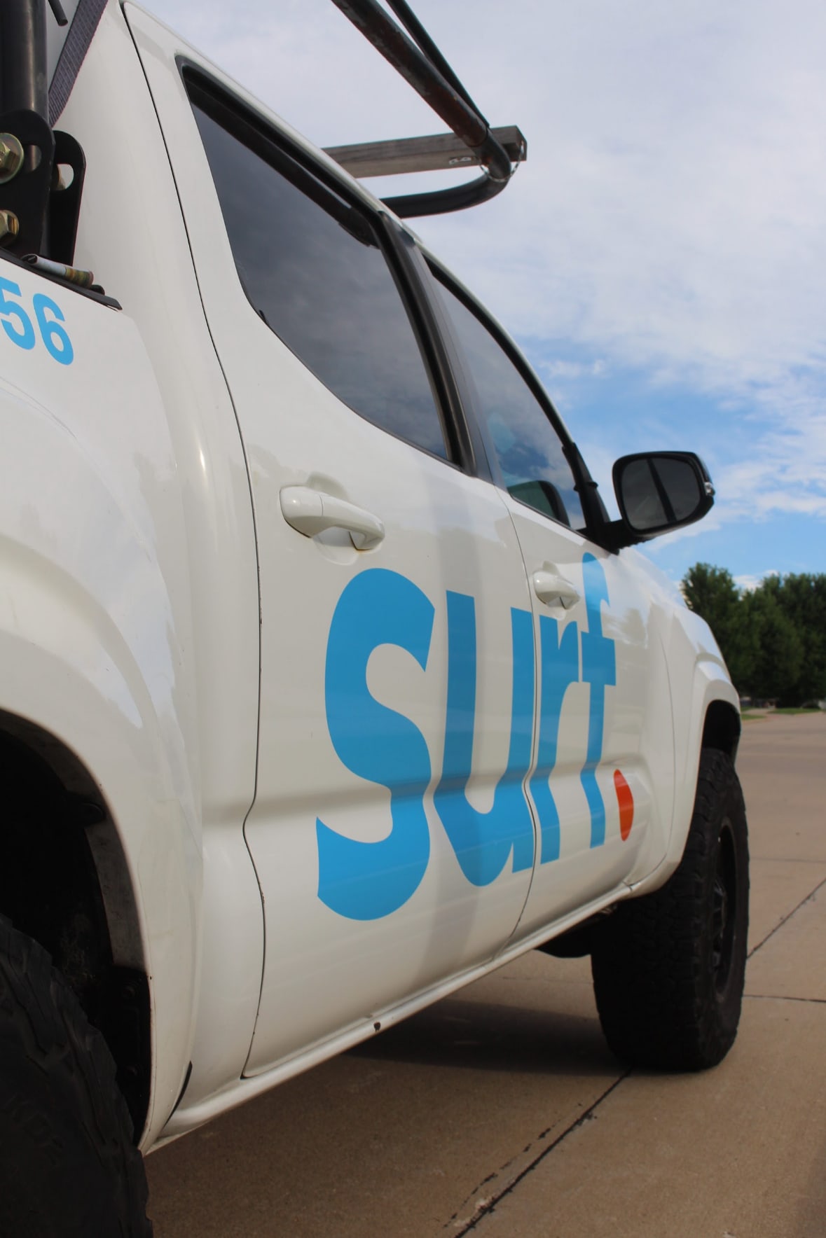 Low-angle view of the surf. branded truck under a bright blue sky